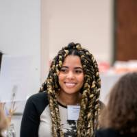 Girls of Color Summit previous event with a girl smiling and listening